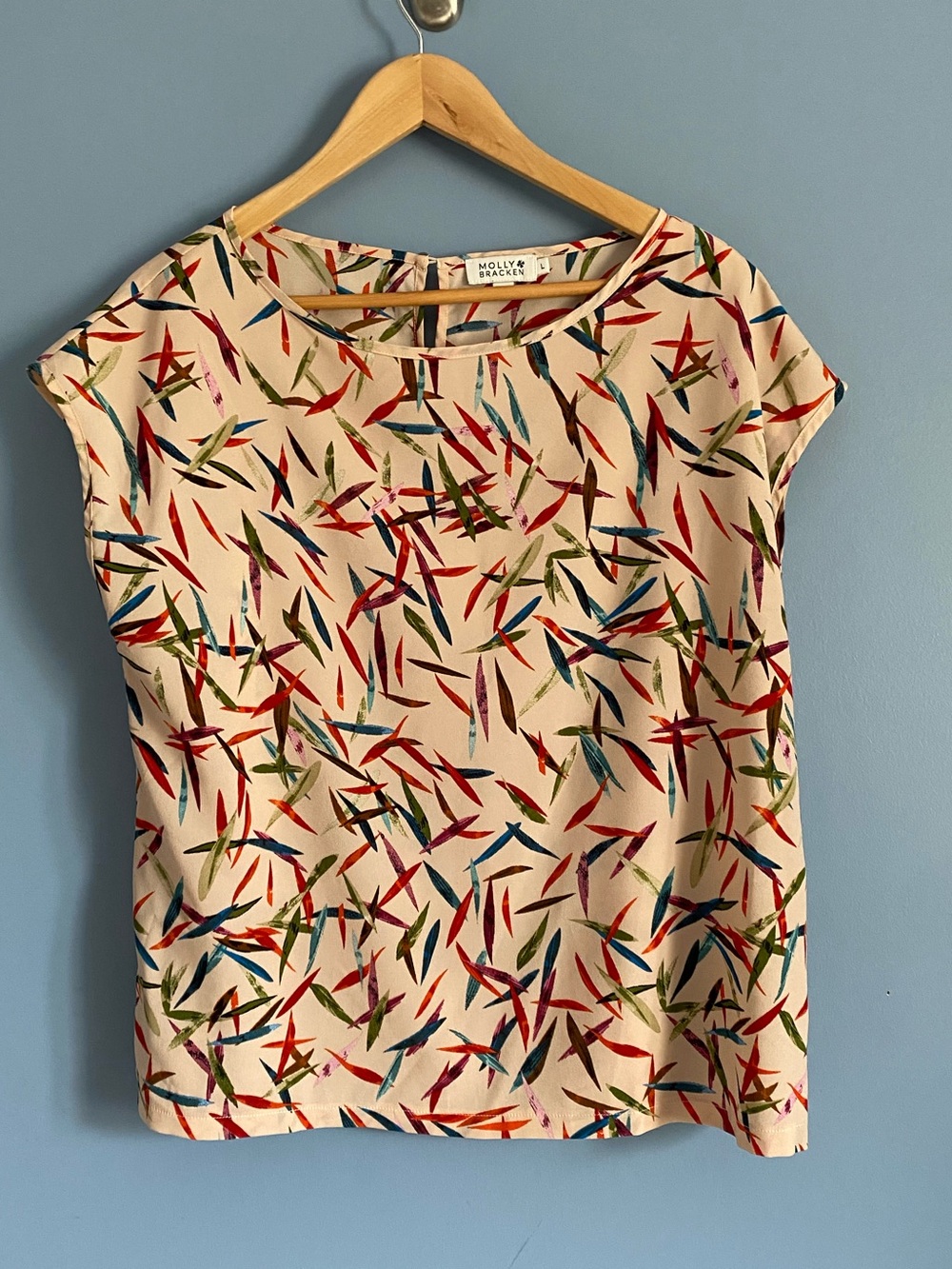 Molly Bracken Cream Top with Red, Blue, Green & Pink Feather Print